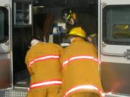 Three firemen at the back of an ambulance